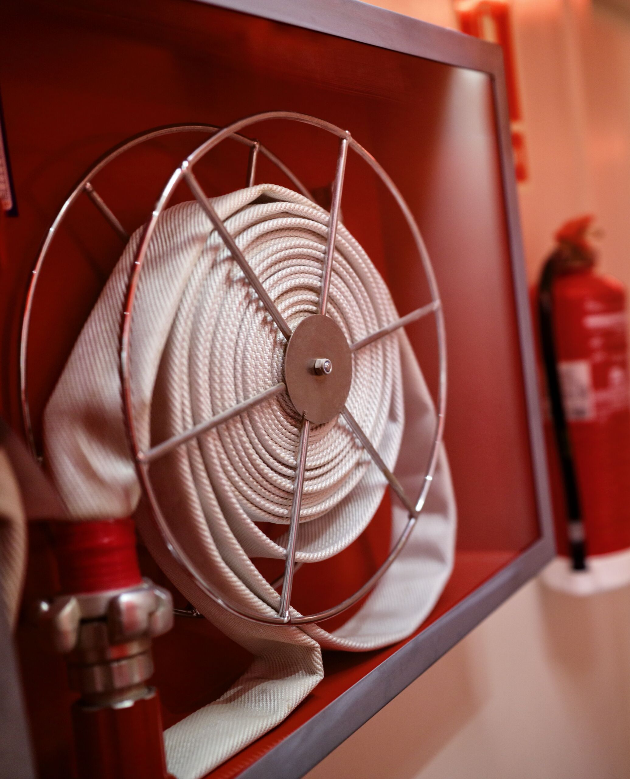 Fire extinguisher and fire hose reel in corridor
